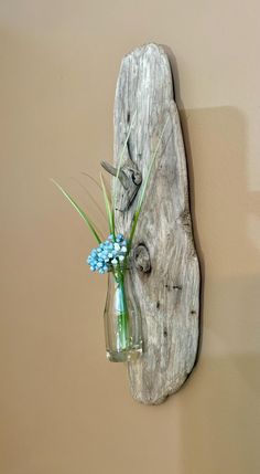 a vase filled with flowers sitting on top of a wooden wall