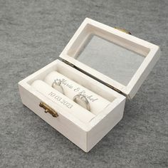 two wedding rings are in a white box