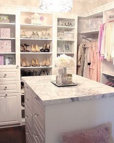 a white closet filled with lots of shoes and other items on top of it's shelves