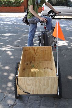 a man standing next to a wooden cart