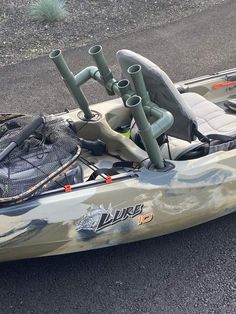 a kayak with two fishing poles attached to the front and back seats on it