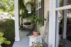 a porch with potted plants on it