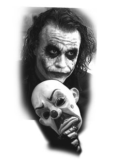 the joker holding a mask with his face painted black and white