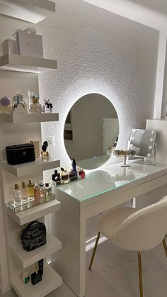 a white desk topped with a mirror and lots of bottles next to a shelf filled with personal items