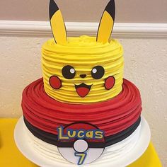 a cake made to look like pikachu on top of a stack of plates