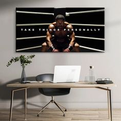 a desk with a laptop on it in front of a wall that says take things personally