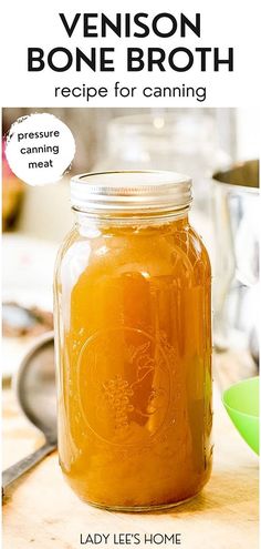 a jar filled with liquid sitting on top of a wooden table