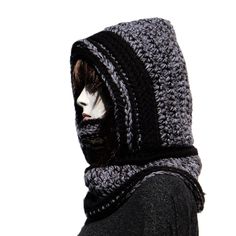 a person wearing a crocheted hood with a black and gray scarf around their neck