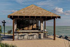 a gazebo sitting on top of a sandy beach next to the ocean