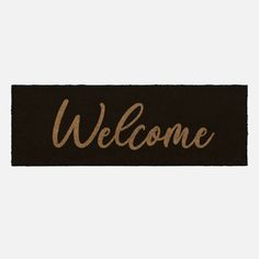 a welcome mat with the word welcome in gold lettering on black and white background,