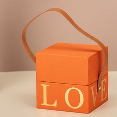 an orange box with the word love painted on it