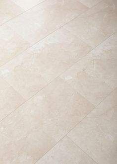 a white toilet sitting on top of a tiled floor