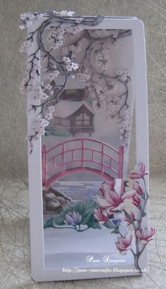 a card with flowers and a bridge in the background