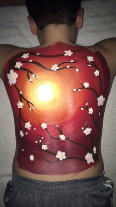 the back of a man's body with flowers painted on it