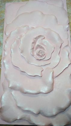 a close up of a paper flower on a table