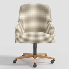 an office chair with wheels and a checkered fabric upholstered on the back