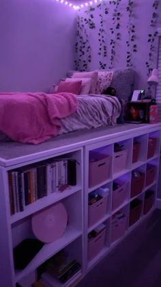 a bedroom with purple lighting and bookshelves