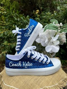 Hand Glittered unbranded canvas sneakers glittered in a gorgeous royal blue.  Made to order. Personalization in white glitter writing to include text of your choice. Glitter is high quality and heat set for minimal glitter loss and lasting quality, though, you may see glitter shedding the first time you wear/try on your shoes.  Although we aim to remove every loose piece of glitter prior to shipment, the shipping process s well as putting them on and adjusting the laces can disrupt the glitter and cause some to flake. This is normal for the first wear or two.    Perfect for brides and glitter girls alike! Personalization to include name and team or gym are optional. If desired, please include custom info in the order notes. Not the shade of blue you desire, check out our shop for light blu Royal Blue Shoes Sneakers, Blue Shoes Sneakers, Cheer Coach Gifts, Royal Blue Shoes, Mom Shoes, Cheer Coach, Cheer Coaches, Cheer Outfits, Cheer Gifts