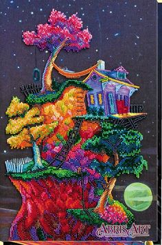 a painting made out of beads with houses and trees on the hill in the background