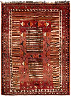 an old rug with geometric designs and fringes on the bottom, in red tones