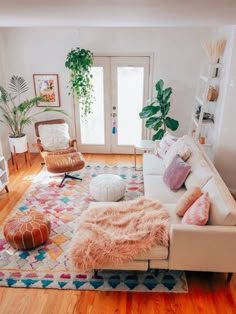 two pictures of a living room with couches and rugs