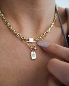 A stunner of a necklace, featuring a singular lock motif and swoon-worthy cubic zirconia encrusted chain. All eyes will be locked on this showstopper. 14k gold plated + palladium plating with brass base Chain measures 15" + 2" extender Lobster clasp Charm measures approx 17mm Links measure approx 4.5mm by 6mm Accented with clear cubic zirconia Protective coating, water resistant Gold Chain Link Necklace, Clasp Necklace, Waterproof Jewelry, Butterfly Earrings, Heeled Loafers, Chain Link Necklace, Link Necklace, Accessories Unique, Mini Black Dress