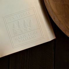 an open book sitting on top of a wooden table