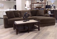 a living room filled with furniture on top of a hard wood floor covered in lots of furniture