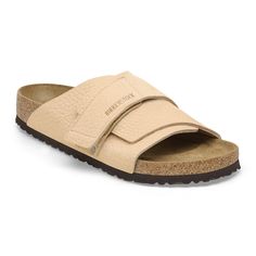 The Kyoto slide maximizes your comfort with its minimalist design. A nubuck leather hook-and-loop strap hugs the foot just right creating the perfect fit day-to-day. It's all grounded in our contoured footbed designed to shape to you with wear for the ultimate in support. Contoured cork-latex footbed creates custom support with wear Grained nubuck leather upper Suede footbed lining helps keep you comfortable Flexible EVA sole Hook-and-loop strap Made in Germany Classic Sandals With Leather Footbed, Classic Everyday Sandals With Leather Footbed, Classic Sandals With Leather Footbed For Everyday, Classic Leather Footbed Sandals For Everyday, Adjustable Leather Slip-on Slides, Suede Slides With Removable Insole And Double Strap, Classic Leather Footbed Sandals With Adjustable Strap, Suede Double Strap Slides With Removable Insole, Leather Slides With Double Straps And Leather Footbed