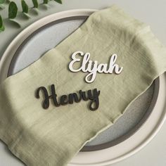 a place setting with an embroidered name on the napkin