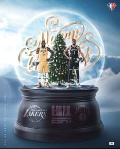 two basketball players standing in front of a christmas tree with the word lakers on it