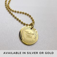 a gold necklace with the words, available in silver or gold on it and an image of