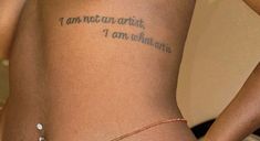 a woman with a tattoo saying i am not an artist