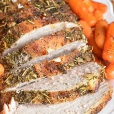 sliced meat and carrots on a plate next to some breaded potatoes with herbs