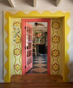 an open door leading into a brightly colored room