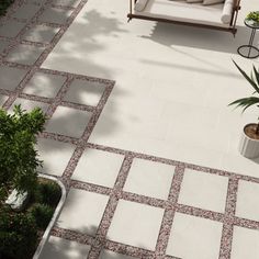 an aerial view of a patio with seating and potted plants in the foreground