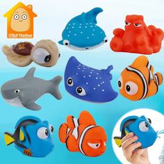 a hand holding a toy with different types of fish on it and an image of a sea animal in the background