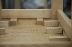 wooden blocks are arranged in front of a mirror