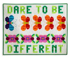 a quilt with the words dare to be different on it