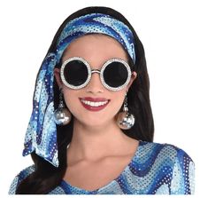 Get Groovy with these disco inspired 70's Oversized Crystal Sunglasses! These lightweight round black framed glasses with UV400 tinted plastic lenses and faux crystals are so versatile and perfect for Halloween, 70's, Elton John, rock stars, pop stars, cosplay and more! Dress, disco earrings and headscarf not included. Other costumes and accessories (earrings, theatrical makeup, GoGo boots) are sold separately on our page – subject to availability. Not designed for vision assistance or correction. One size fits most adults and teens and may fit some larger children. Party Sunglasses With Tinted Round Lenses, Round Tinted Sunglasses For Party, Round Tinted Sunglasses For Parties, Round Tinted Lens Sunglasses For Parties, Disco Earrings, Retro Inspired Outfits, 70s Costume, Crystal Sunglasses, Theatrical Makeup