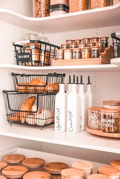 an organized pantry with white bedroom with plants bohemian jars and bread in baskets on the shelves