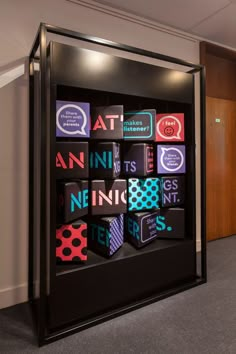 an office cubicle with various types of business cards on it's display case