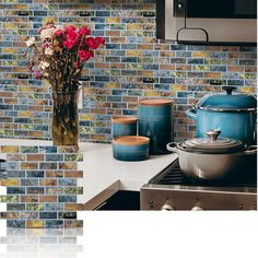 a vase with flowers sitting on top of a counter next to pots and pans