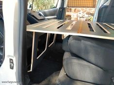 the back end of a vehicle with a table attached to it