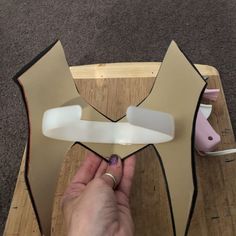 someone is making a star shaped object out of cardboard