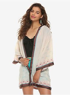 You won't want to be incognito like Jasmine when you're wearing this hooded kimono! Inspired by her shawl when she visits the markets in Aladdin , it features a border print with the Genie's lamp and lotus flowers, as well as clouds and stars blending further upwards. Each edge is finished with a striped ribbon applique that gives a graceful weighted movement to this lightweight kimono. Officially licensed by Her Universe  55% rayon; 45% nylon Wash cold; hang dry Imported Listed in Princess Disneybound, Hooded Kimono, Ribbon Applique, Plus Size Disney, Clouds And Stars, Aladdin Jasmine, Disney Princess Fashion, Culture Clothing, Twist Front Top