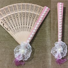 two pink and white hand fans with pearls on the sides, one is decorated with lace