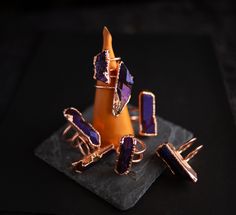 These rings feature purple/blue Titanium Quartz Points set in a double band and encased in pure electroformed copper.   Size:  A- US 10 B- US 8.25 C- US 8 D- US 7 E- US 7 F- US 6 G- US 4 These rings are not adjustable. All jewelry is one-of-a-kind and handmade by me for Bast & Baetyl Alchemy. Symbolic Electroformed Gold Jewelry, Adjustable Electroformed Purple Jewelry, Electroformed Brass Ring, Luxury Electroformed Ring Jewelry, Electroformed Ring, Titanium Quartz, Quartz Ring, Quartz Points, Alchemy