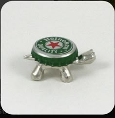 a bottle cap shaped like a turtle sitting on top of a table