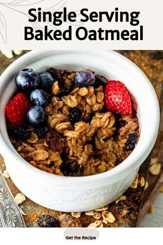 a white bowl filled with granola and berries